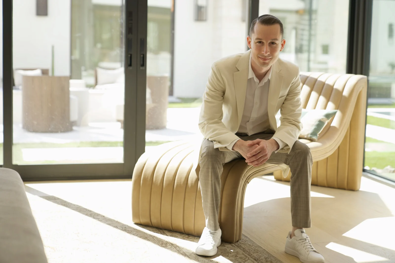 Justin Taylor seated in a bright modern lounge