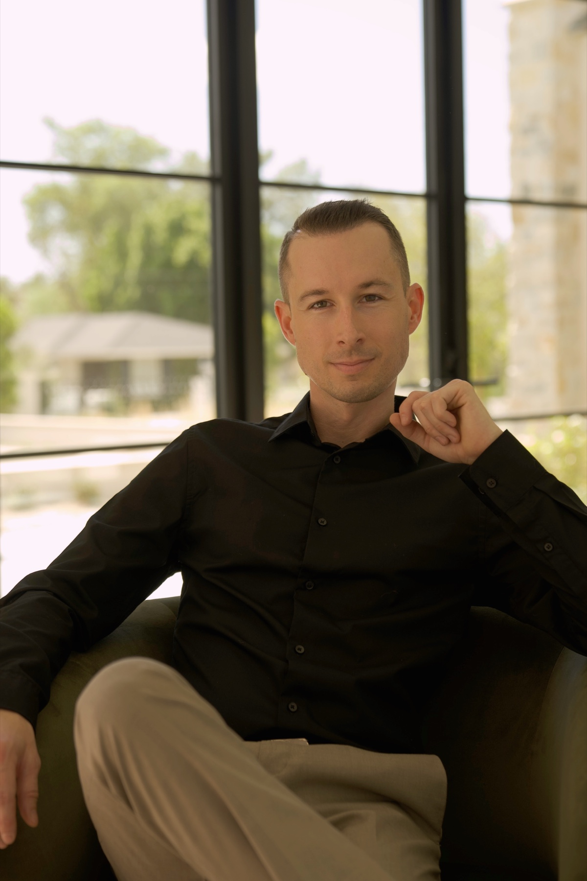 Justin Taylor seated by a window