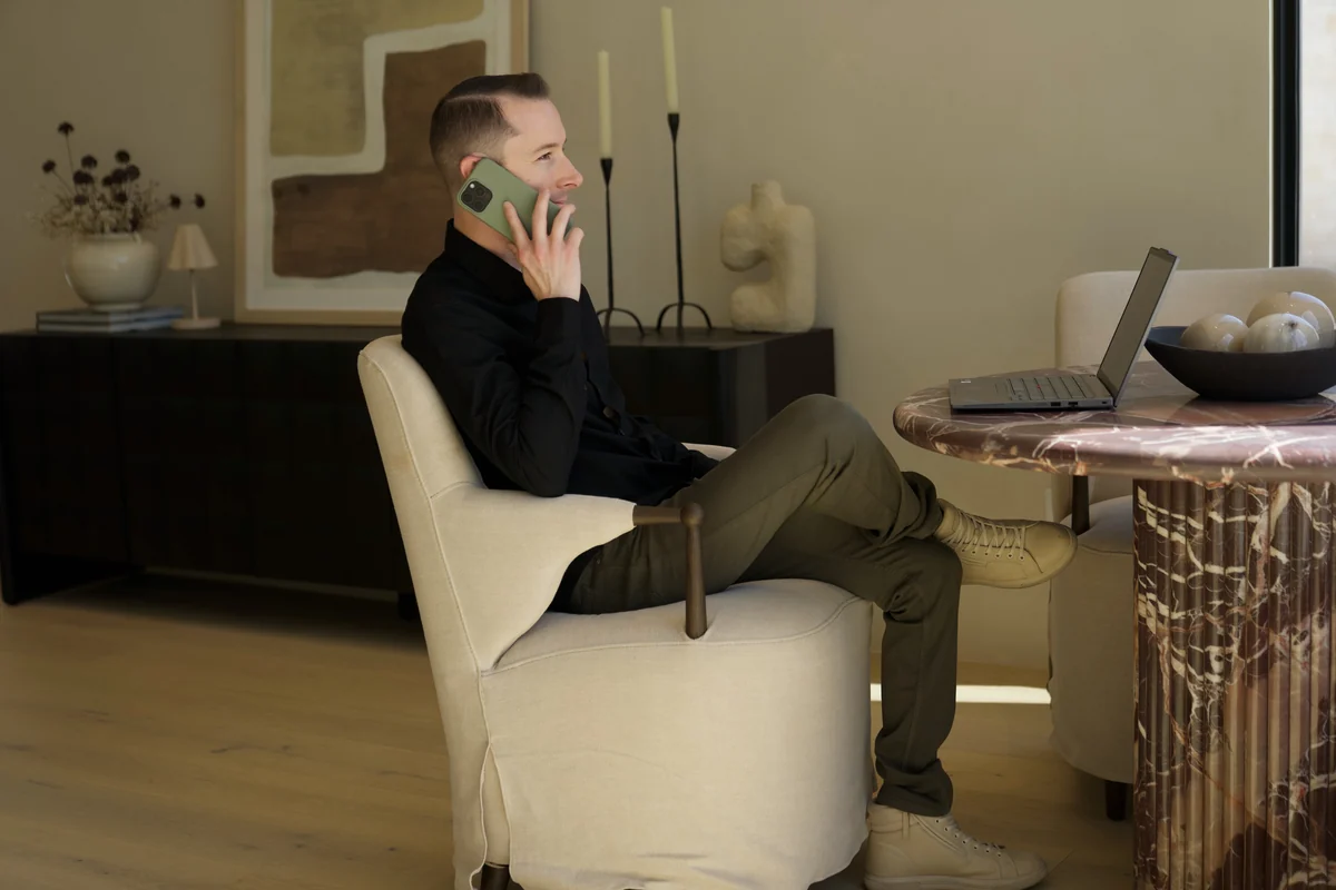 Justin Taylor on a call with a laptop beside him
